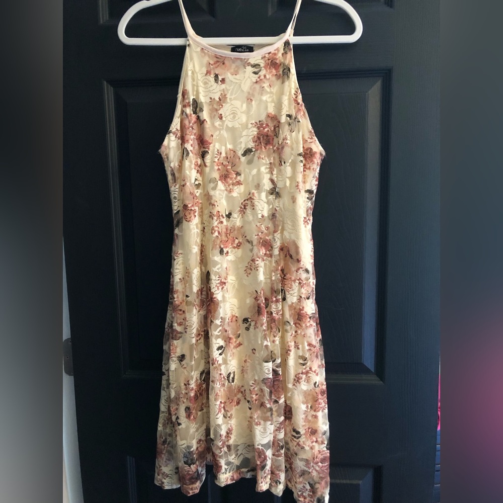 Cream colored dress, covered in lacy detail with muted pink roses, mini
